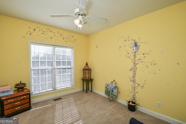 misc room with light carpet and ceiling fan