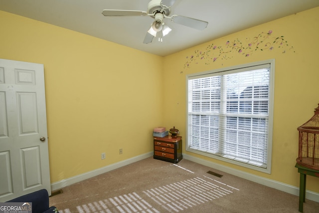 misc room featuring ceiling fan and light carpet