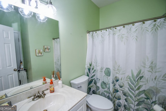 bathroom with vanity, walk in shower, and toilet