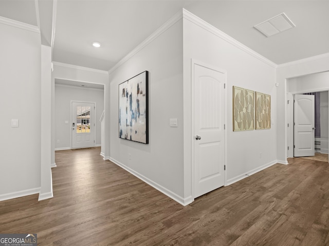 hall featuring crown molding and dark hardwood / wood-style floors