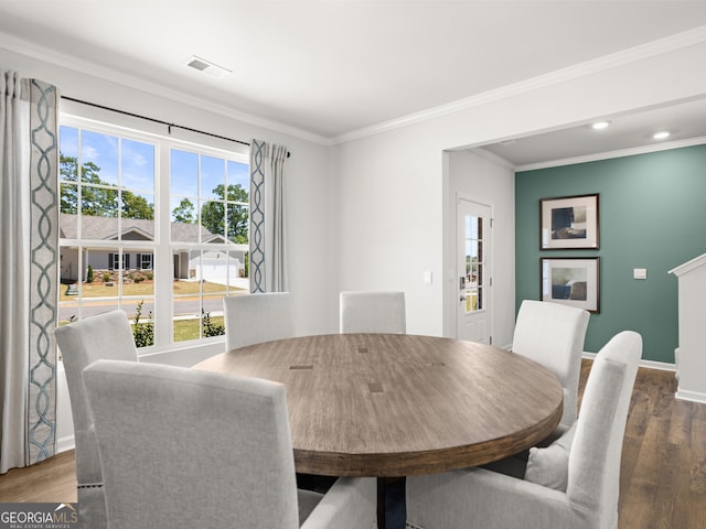 dining area featuring ornamental molding and hardwood / wood-style floors