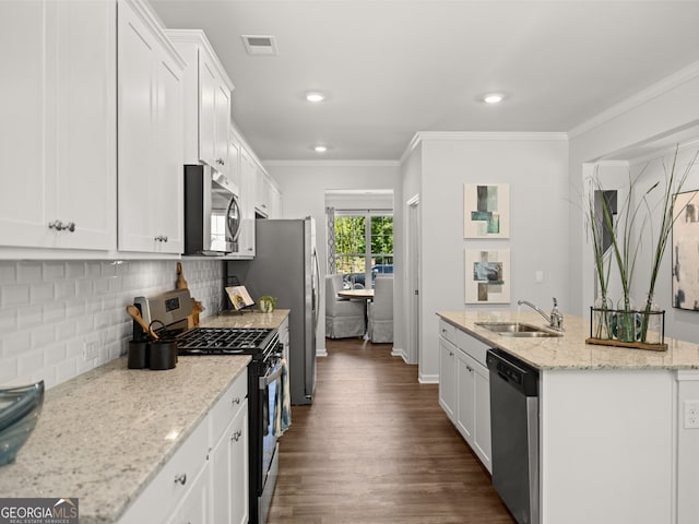 kitchen with sink, stainless steel appliances, light stone counters, white cabinets, and decorative backsplash