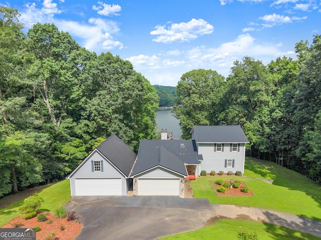 3366 Small Woods Ln, Gainesville, GA 30506 - traditional-style house featuring asphalt driveway, a front lawn, a metal roof, an attached garage, and a water view