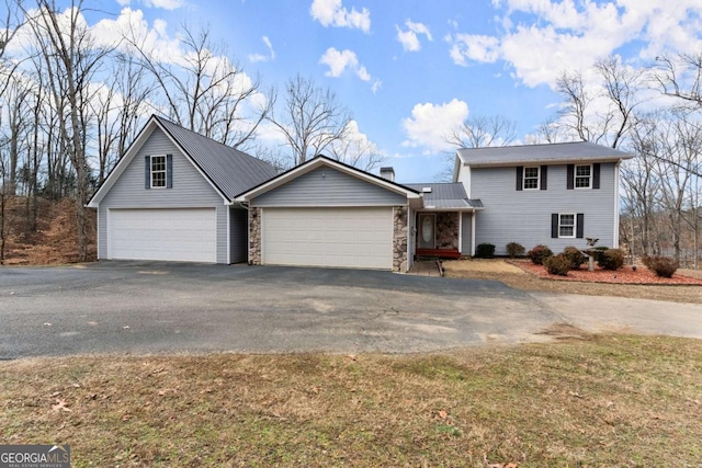3366 Small Woods Ln, Gainesville, GA 30506 - view of front of property featuring metal roof, aphalt driveway, an attached garage, and stone siding