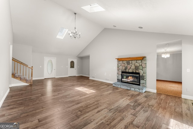 3366 Small Woods Ln, Gainesville, GA 30506 - unfurnished living room with a skylight, a chandelier, stairs, a stone fireplace, and high vaulted ceiling