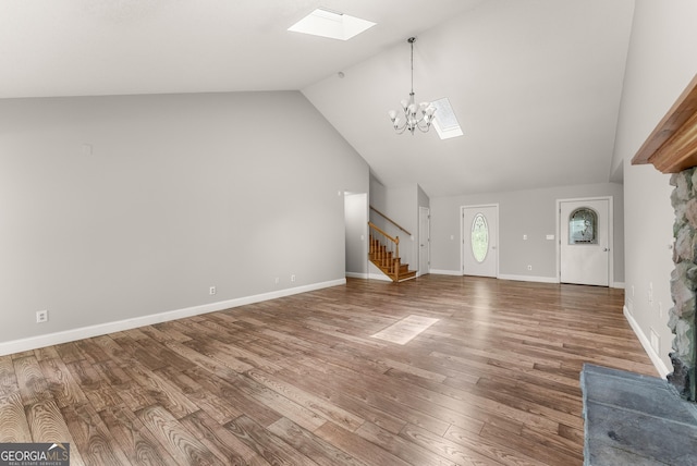 3366 Small Woods Ln, Gainesville, GA 30506 - unfurnished living room with a skylight, stairs, a chandelier, wood finished floors, and vaulted ceiling
