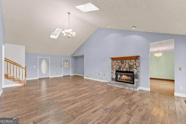 3366 Small Woods Ln, Gainesville, GA 30506 - unfurnished living room with a fireplace, a skylight, and wood finished floors