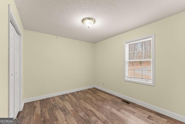 3366 Small Woods Ln, Gainesville, GA 30506 - unfurnished bedroom with a closet, baseboards, and wood-type flooring