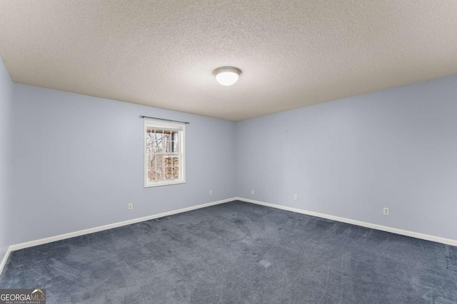 3366 Small Woods Ln, Gainesville, GA 30506 - spare room featuring a textured ceiling, baseboards, and dark carpet