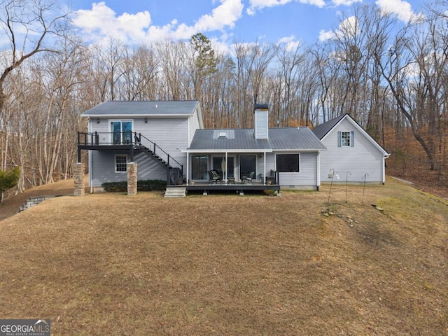 3366 Small Woods Ln, Gainesville, GA 30506 - back of property with a chimney, a lawn, a deck, metal roof, and stairway