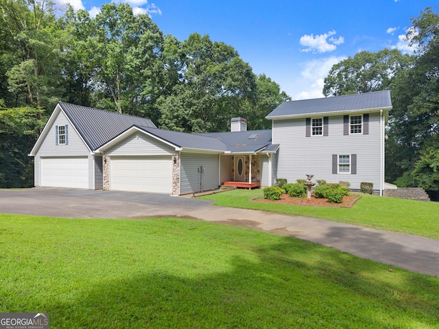 3366 Small Woods Ln, Gainesville, GA 30506 - traditional-style house with asphalt driveway, a metal roof, a front lawn, an attached garage, and a chimney