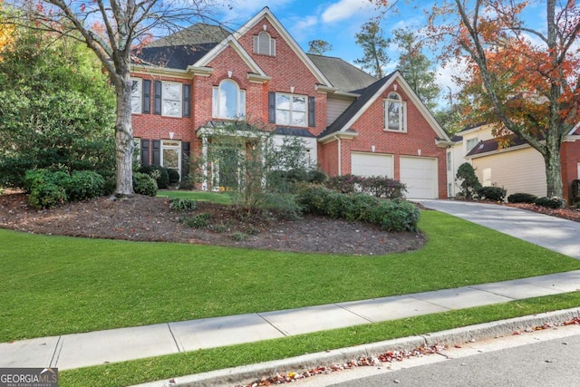 view of front of property with a garage and a front lawn