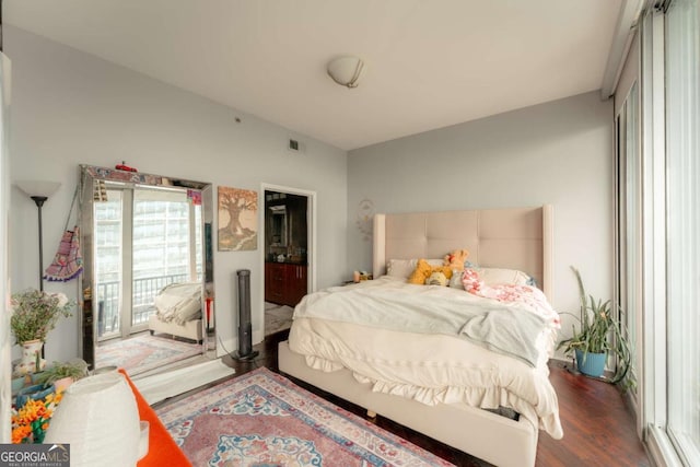 bedroom with dark hardwood / wood-style flooring and access to exterior