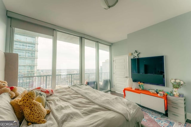 bedroom with expansive windows and access to exterior