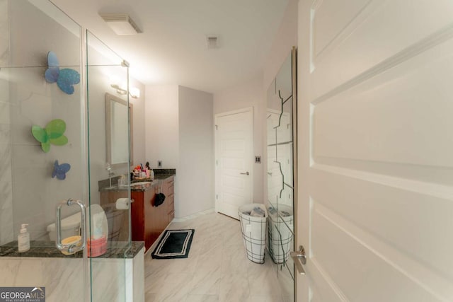 bathroom with vanity and a shower with shower door