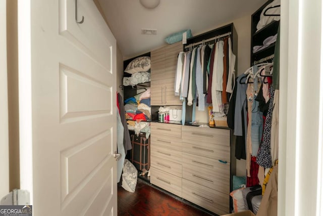 spacious closet with dark hardwood / wood-style floors