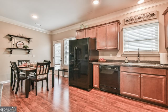 kitchen with ornamental molding, sink, light hardwood / wood-style floors, and black appliances