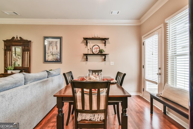 dining room featuring hardwood / wood-style floors and ornamental molding