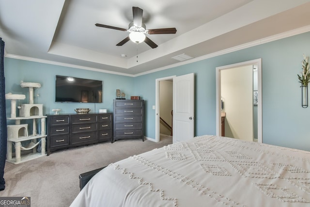 bedroom featuring ceiling fan, ornamental molding, a raised ceiling, and light carpet