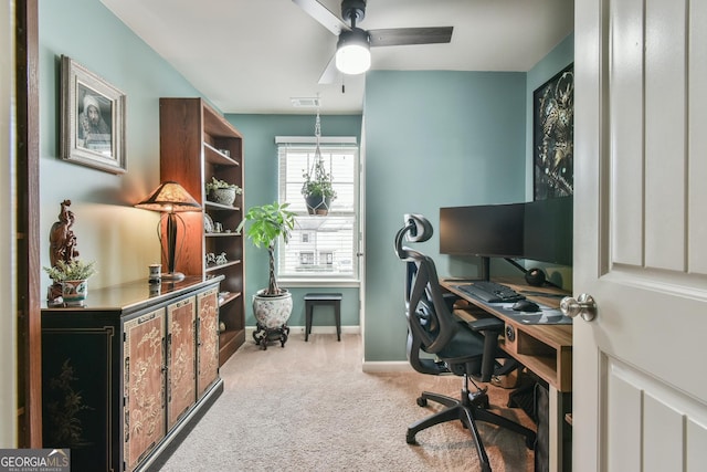 carpeted office featuring ceiling fan