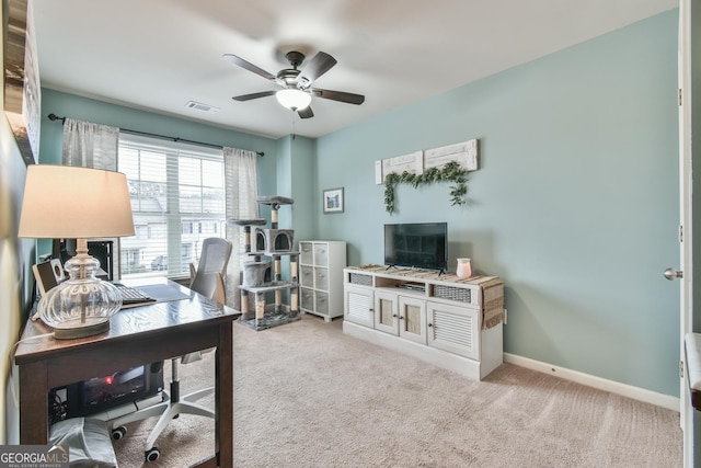 home office featuring light carpet and ceiling fan