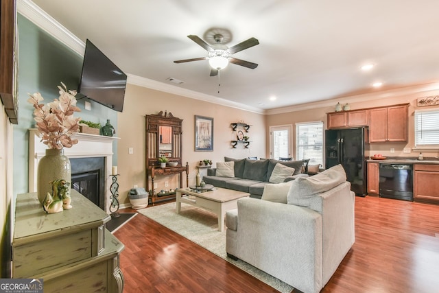 living room with ceiling fan, ornamental molding, and hardwood / wood-style floors