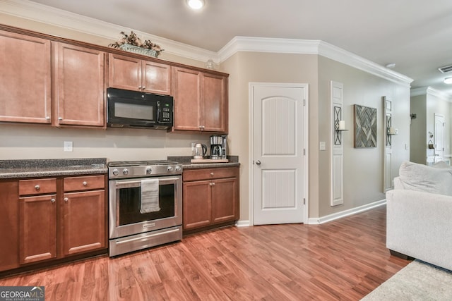 kitchen with hardwood / wood-style floors, ornamental molding, and stainless steel range with gas stovetop