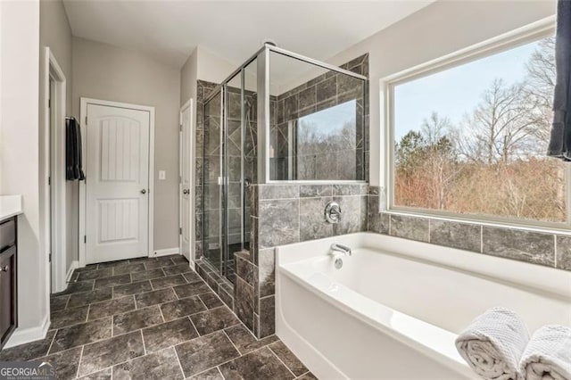 bathroom featuring vanity, shower with separate bathtub, and a healthy amount of sunlight