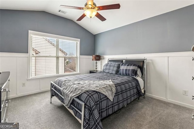 carpeted bedroom with ceiling fan and vaulted ceiling