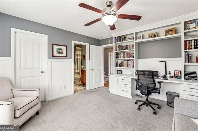 office space featuring light carpet and ceiling fan