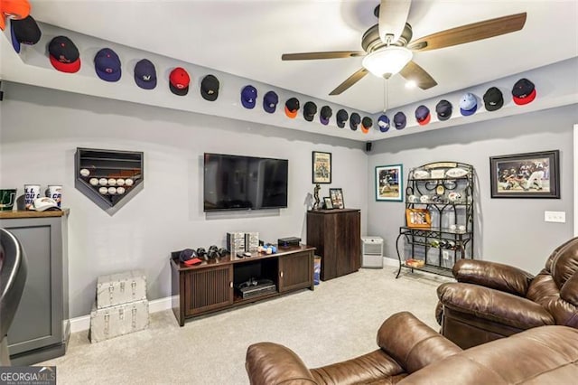 living room with ceiling fan and carpet