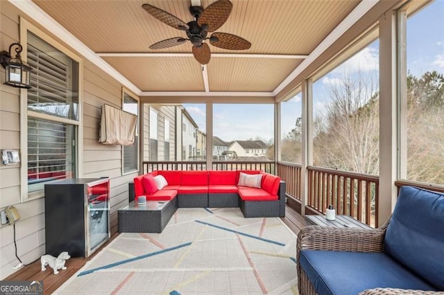 sunroom / solarium with a wealth of natural light, wooden ceiling, and ceiling fan