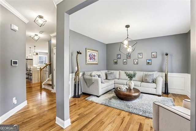 living room featuring hardwood / wood-style flooring and ornamental molding