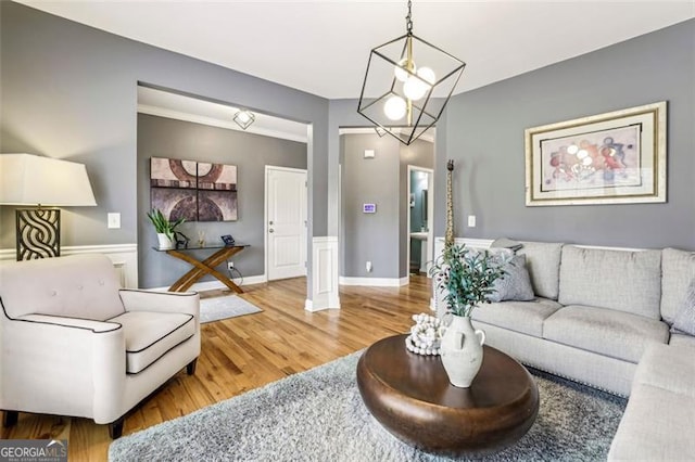 living room with an inviting chandelier and hardwood / wood-style flooring