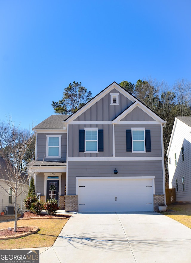 view of front of property featuring cooling unit and a garage