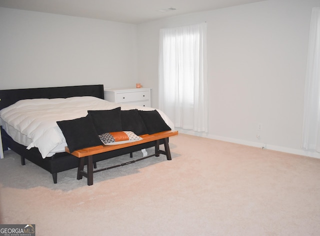 bedroom with light colored carpet