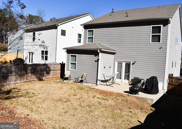 back of property with a patio and a lawn