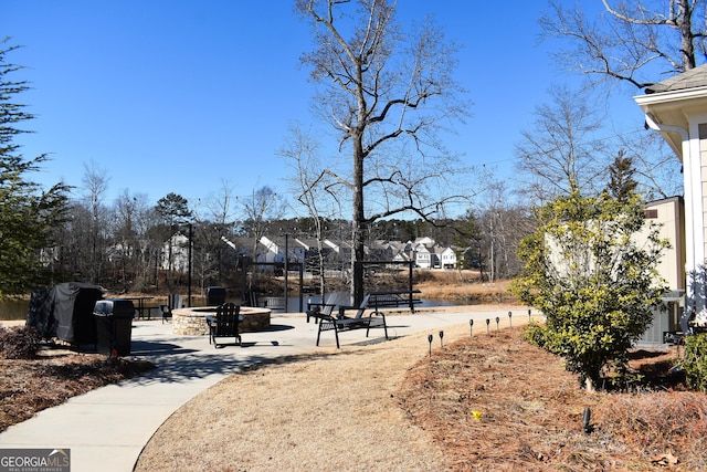 view of home's community featuring a fire pit and a patio