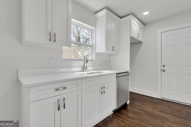 kitchen featuring dark wood-type flooring, dishwasher, sink, and white cabinets