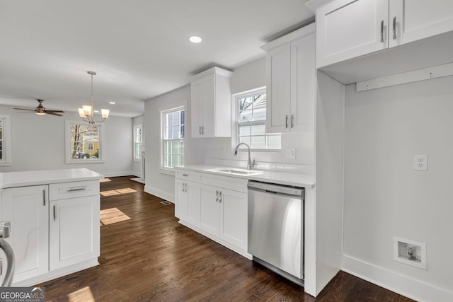 kitchen with sink, dark wood-type flooring, white cabinetry, hanging light fixtures, and stainless steel dishwasher