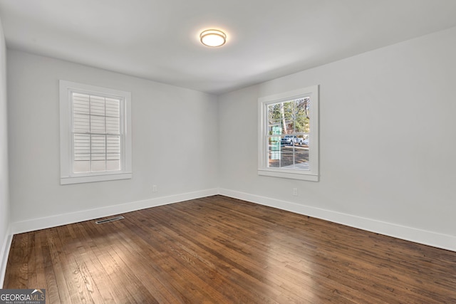 spare room featuring wood-type flooring