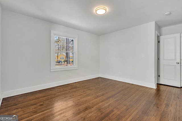 empty room featuring dark hardwood / wood-style flooring