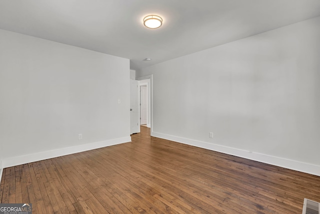 spare room with hardwood / wood-style floors