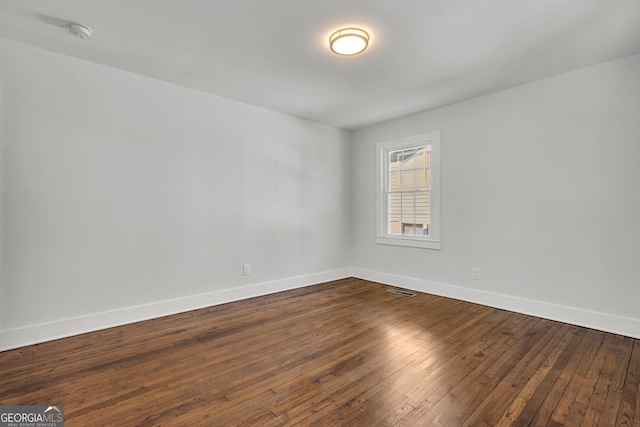 unfurnished room featuring wood-type flooring