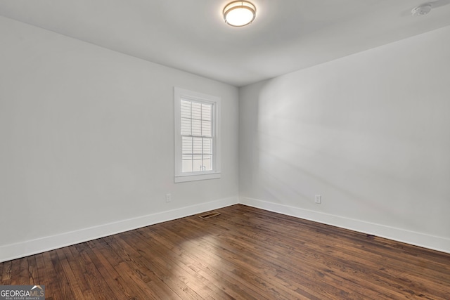 unfurnished room featuring dark hardwood / wood-style floors