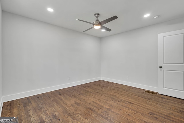 spare room featuring dark hardwood / wood-style flooring and ceiling fan