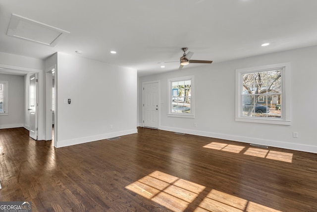 unfurnished living room with dark hardwood / wood-style flooring and ceiling fan