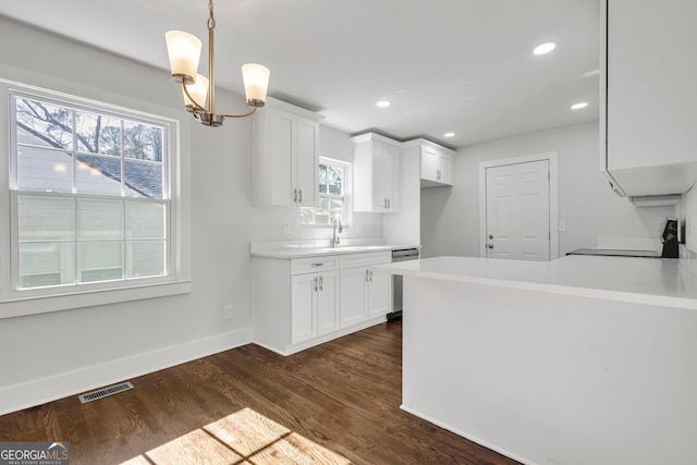 kitchen featuring white cabinetry, a wealth of natural light, dark wood-type flooring, and stove