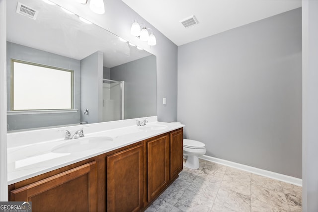 bathroom featuring vanity, toilet, and an enclosed shower