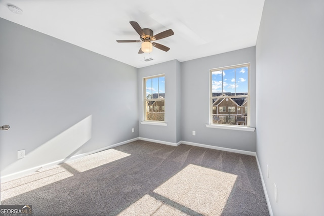 empty room with ceiling fan and carpet